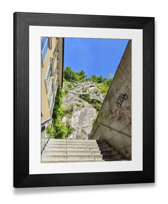 Framed Print : Modern stone staircase leads to a green rock under a clear sky