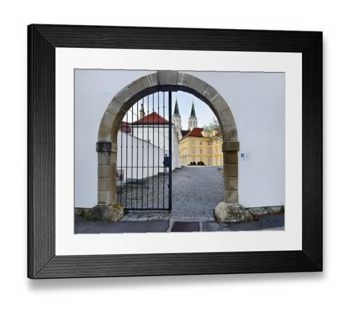 Framed Print : View through a Tor tor to a cobbled courtyard and church towers of a historic building