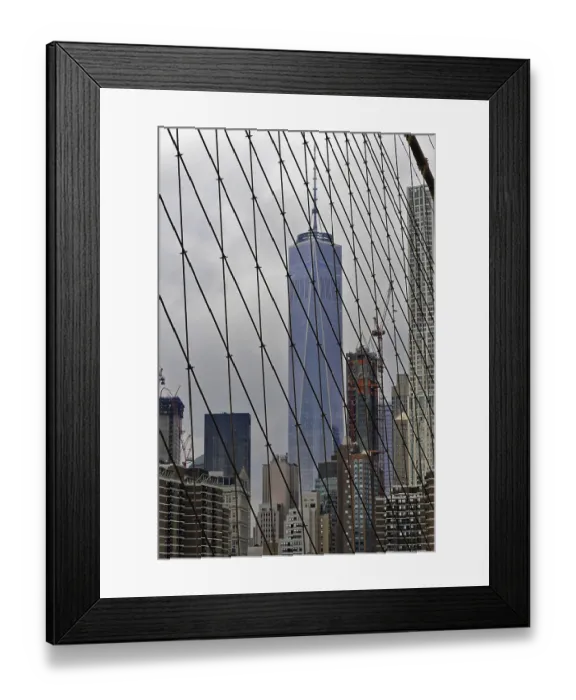 Framed Print : View of skyscrapers through the cables of the Brooklyn Bridge in New York