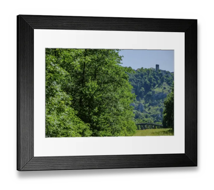 Framed Print : A wooded hill with a castle tower in the background and a bridge in the foreground Framed Print : A wooded hill with a castle tower in the background and a bridge in the foreground