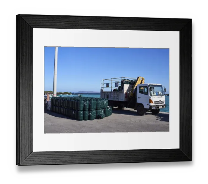 Framed Print : Container being unloaded, cargo consists of gas cylinders