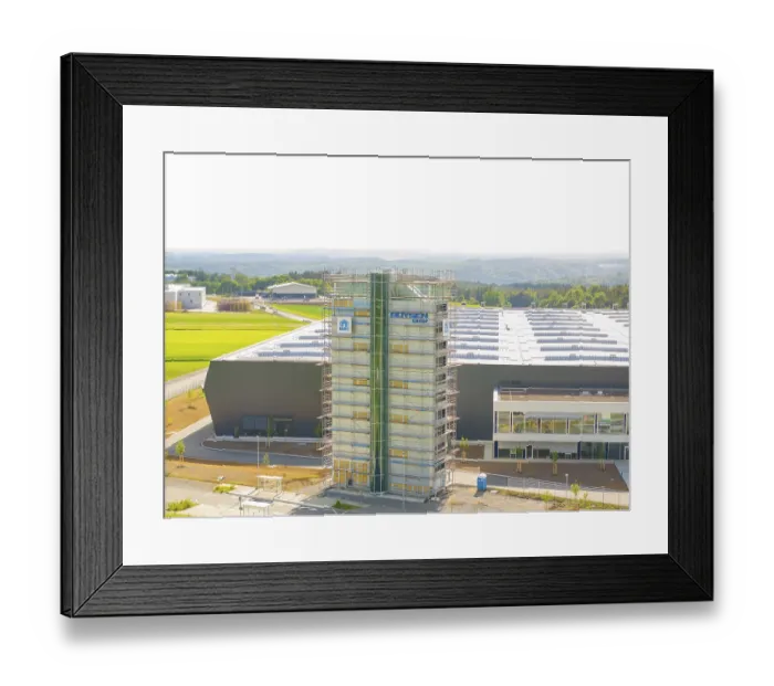 Framed Print : Front view of an industrial building with scaffolding and fields in the background Framed Print : Front view of an industrial building with scaffolding and fields in the background