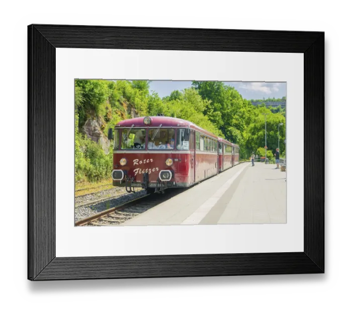 Framed Print : Close-up of a red train on a sunny platform Framed Print : Close-up of a red train on a sunny platform