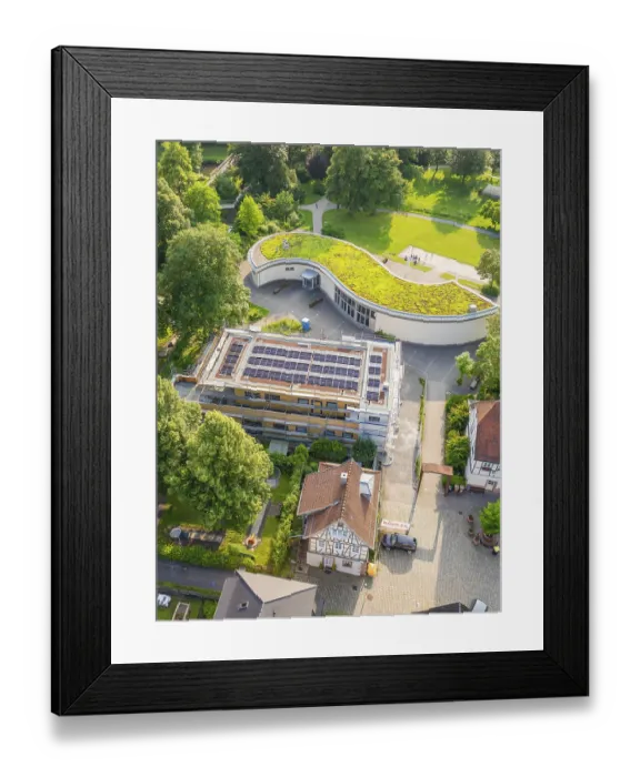 Framed Print : Building under construction with solar modules and green roof