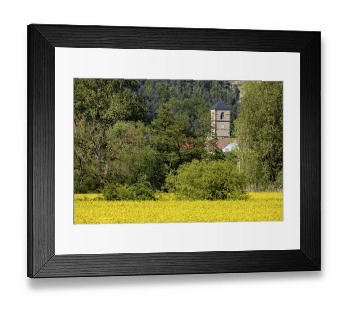 Framed Print : A village is dominated by a church tower
