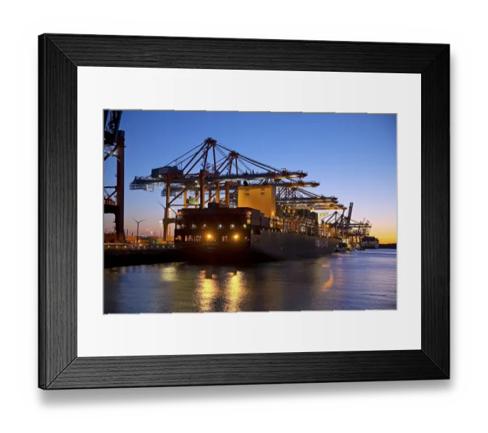 Framed Print : Container ships at the Eurogate container terminal in the evening with an atmospheric sunset Framed Print : Container ships at the Eurogate container terminal in the evening with an atmospheric sunset