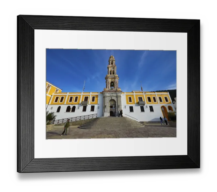 Framed Print : Historic building with baroque church tower and people on a square under blue sky