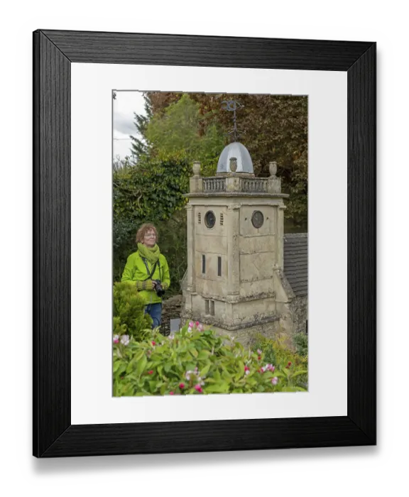 Framed Print : Visitor looking at church tower at miniature village