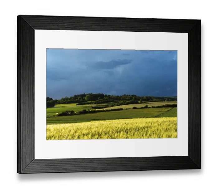 Framed Print : Dramatic cloudy sky with approaching storm and last rays of sunshine