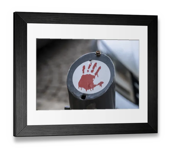 Framed Print : Red handprint as a protest symbol on stickers in the cityscape