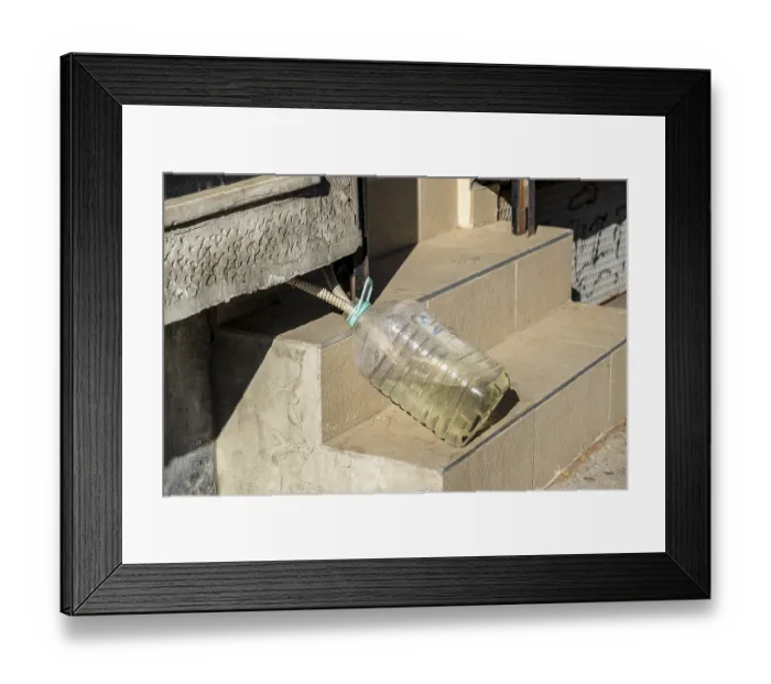 Framed Print : Improvised water drainage with plastic bottle on stairs