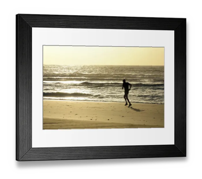 Framed Print : Jogging on the beach at sunrise