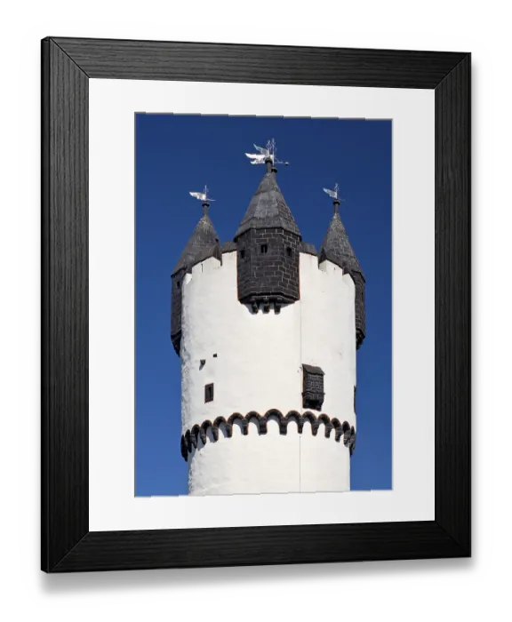 Framed Print : Keep with stone spire and smaller turrets on the battlements against a blue sky