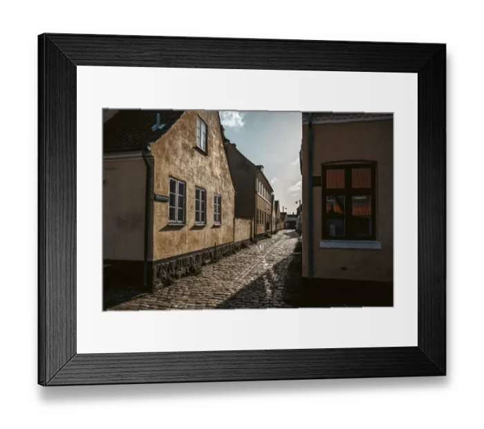 Framed Print : A sun drenched laneway in Danish fishing village of Dragor Framed Print : A sun drenched laneway in Danish fishing village of Dragor