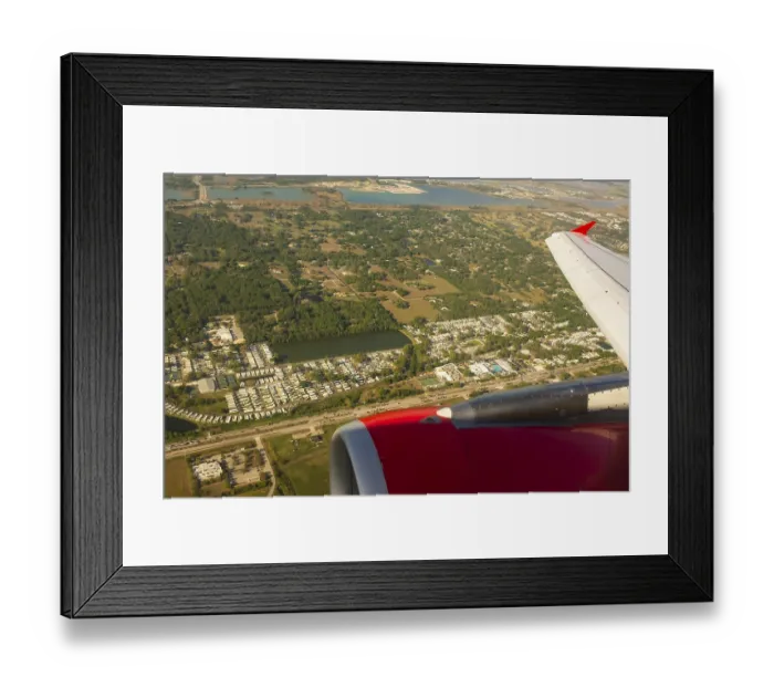 Framed Print : A colour landscape image looking out through airplane window showing land