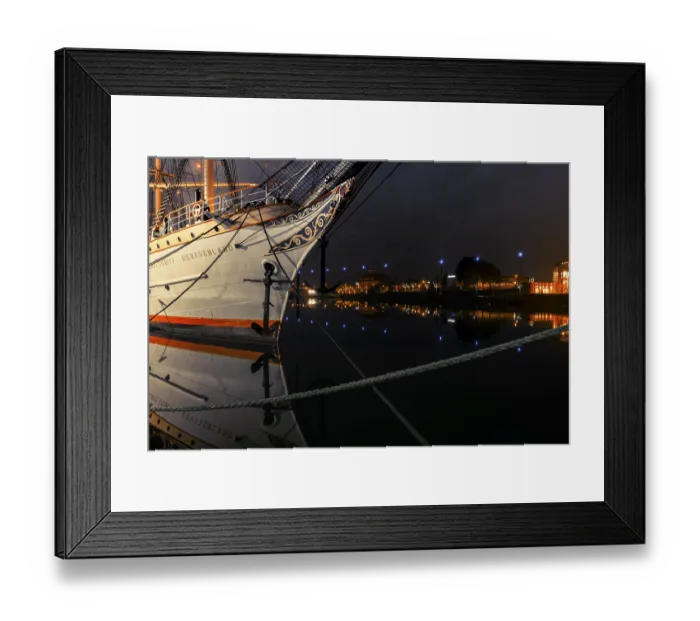 Framed Print : View of the bow of a tethered sailing ship at night