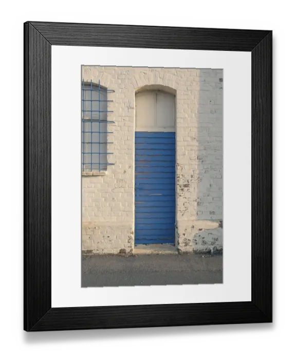 Framed Print : Detailed view of an old blue weathered long hall door in the evening light