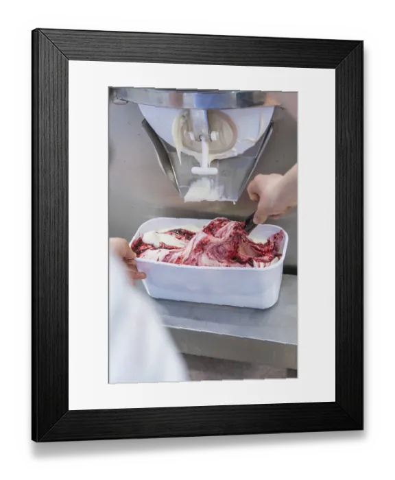 Framed Print : Ice cream is scraped out of a machine