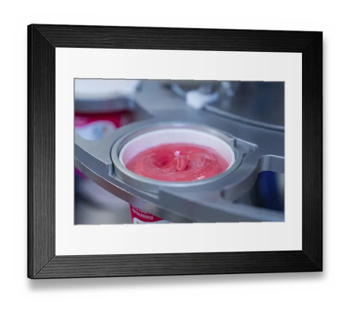 Framed Print : Raspberry ice cream in a cup during the filling process