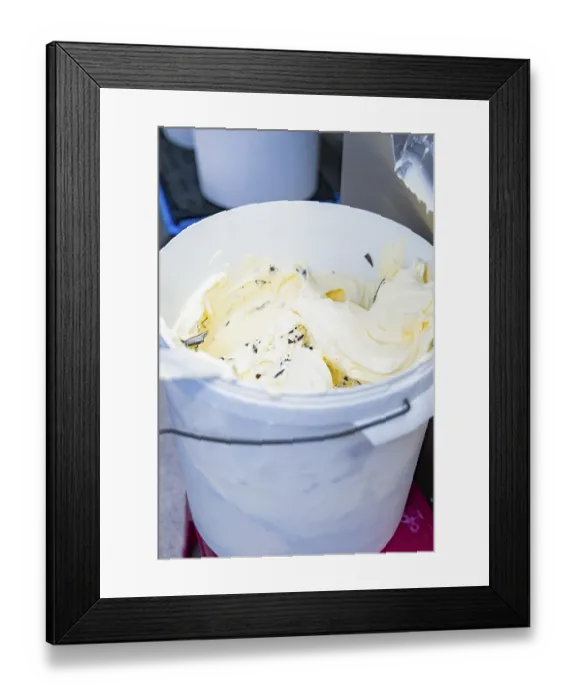 Framed Print : Vanilla ice cream with chocolate chips is stored in a white bucket