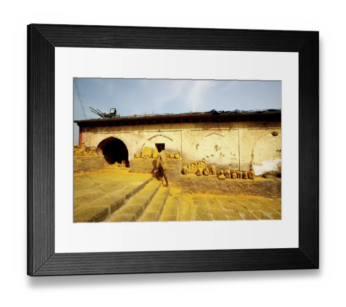 Framed Print : Devotee paying respects to statues immersed in turmeric powder at Jejuri temple