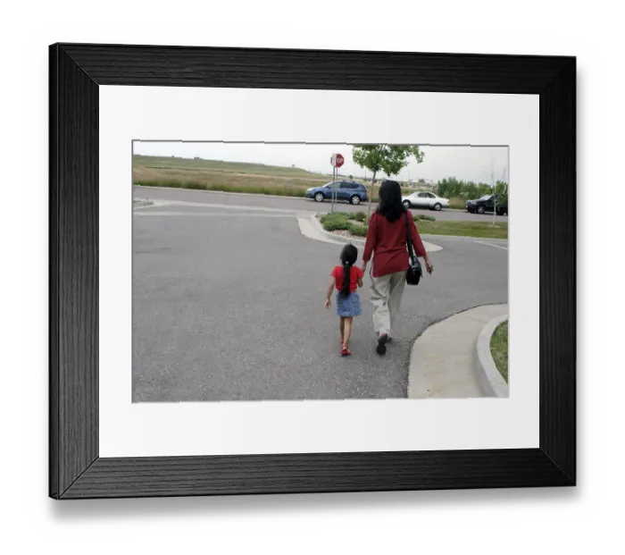 Framed Print : Mother and daughter walking on road