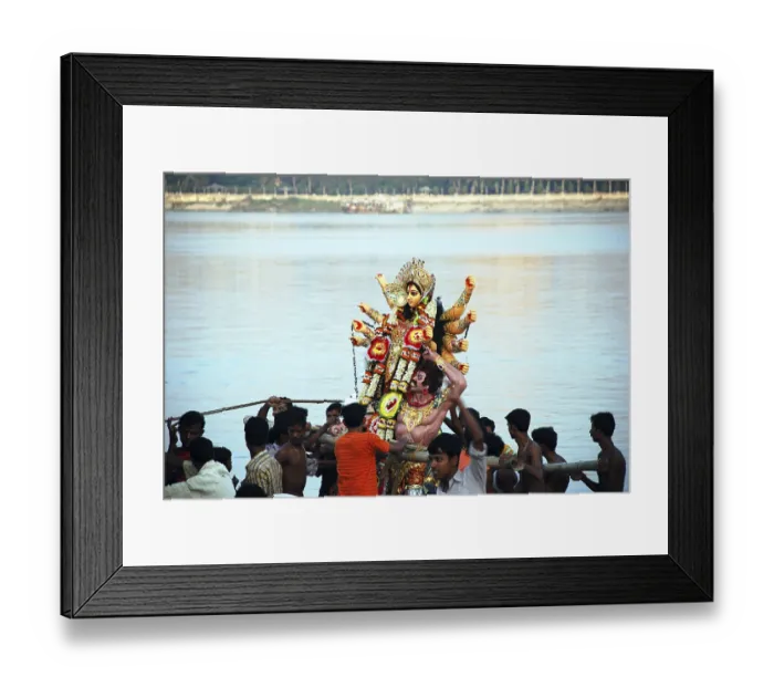 Framed Print : Devotees immersing Durga model in river