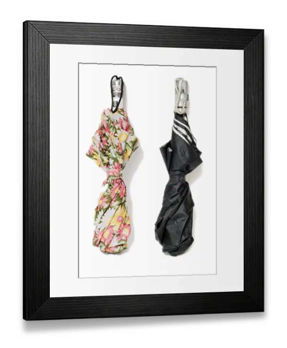Framed Print : One ladies umbrella with a floral pattern and a black umbrella for men Framed Print : One ladies umbrella with a floral pattern and a black umbrella for men