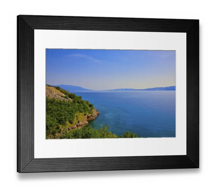 Framed Print : A peaceful coastal landscape with clear blue sea and sunny sky