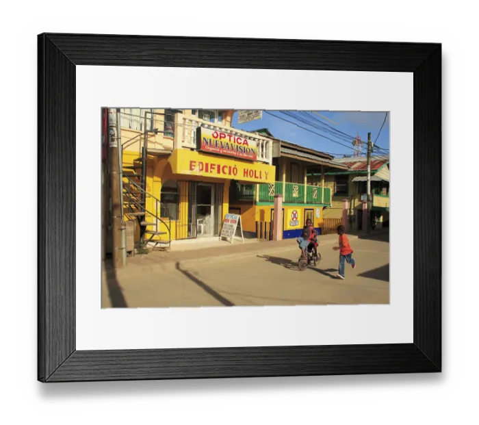 Framed Print : Children cycling on street, Roatan island