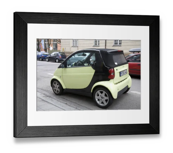 Framed Print : Small light green color smart car parked on the street