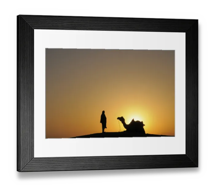 Framed Print : Glorious sunrise man with camel on sand dunes