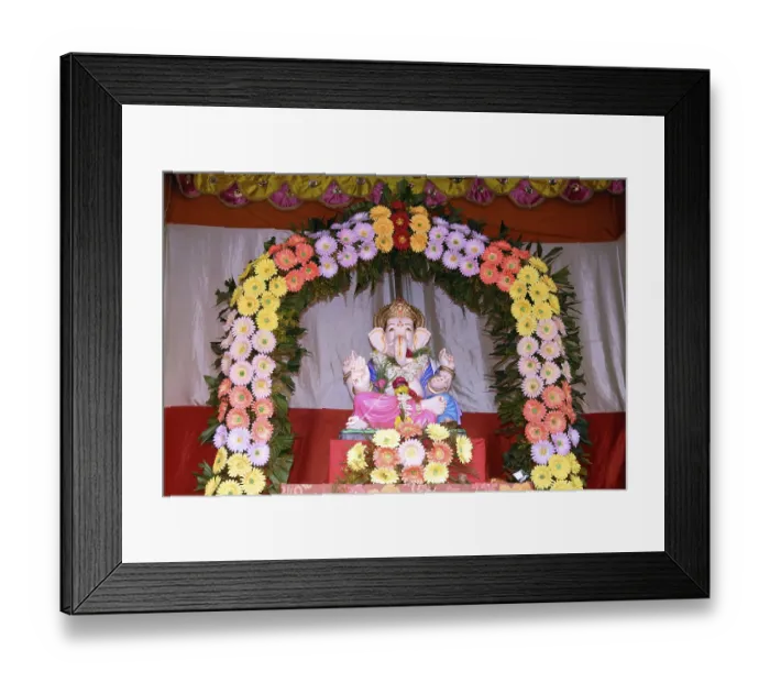 Framed Print : Idol of Lord Ganesh kept in gaily decorated frame of colourful flowers elephant headed god