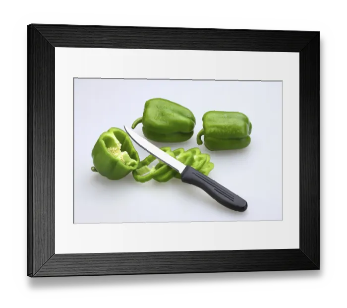 Framed Print : Sharp knife with black handle with slices of Green Capsicums Latin Capsicum Annuum