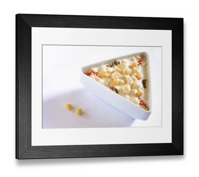 Framed Print : Vegetable salad, boondi raita spiced with chilli powder in triangle plate on white background
