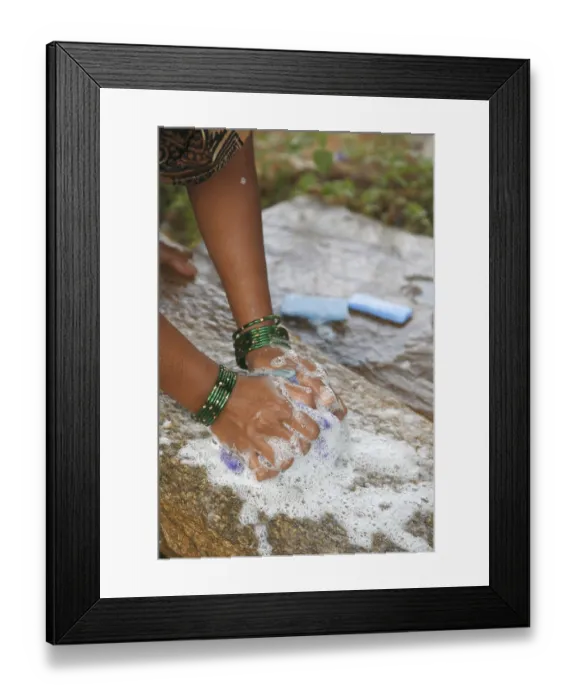 Framed Print : Lady washing cloths with soap rubbing on stone Framed Print : Lady washing cloths with soap rubbing on stone