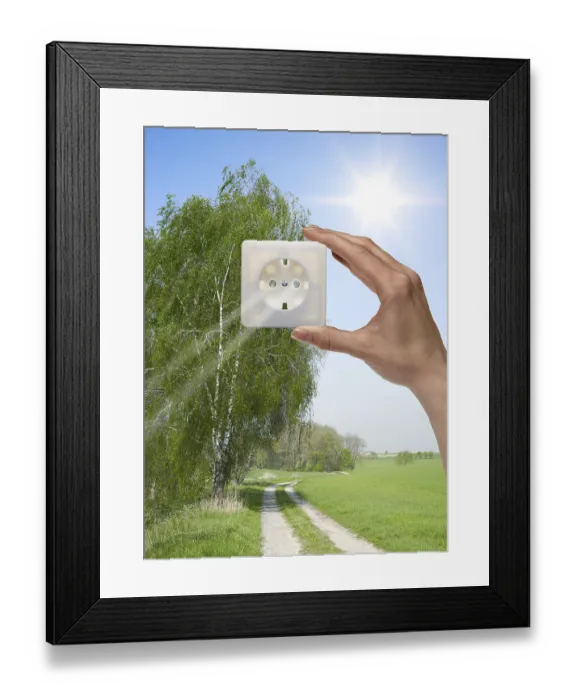 Framed Print : Symbolic solar energy theme showing a idyllic outdoor scenery with human hand holding a electrical socket in front of Framed Print : Symbolic solar energy theme showing a idyllic outdoor scenery with human hand holding a electrical socket in front of