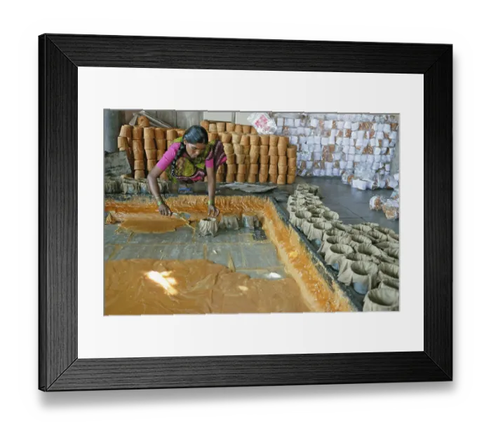 Framed Print : Women putting jaggery in moulds