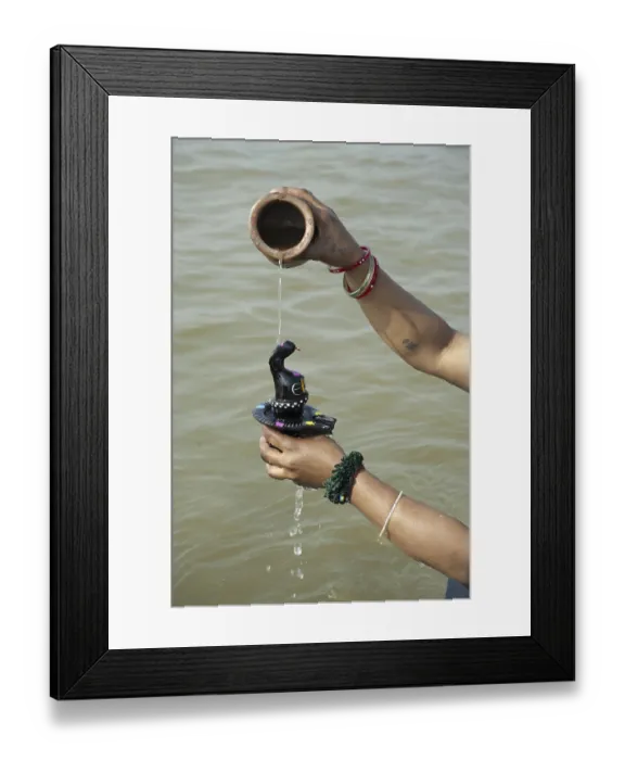 Framed Print : Woman bathing shivling in sangam at uttar pradesh India