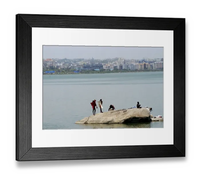 Framed Print : Poor people washing clothes in Hussain Sagar lake in Hyderabad Framed Print : Poor people washing clothes in Hussain Sagar lake in Hyderabad