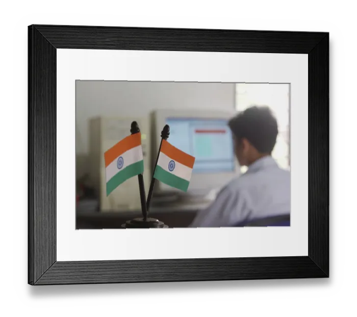 Framed Print : Indian National Flag, Tiranga, Man working on computer on the background