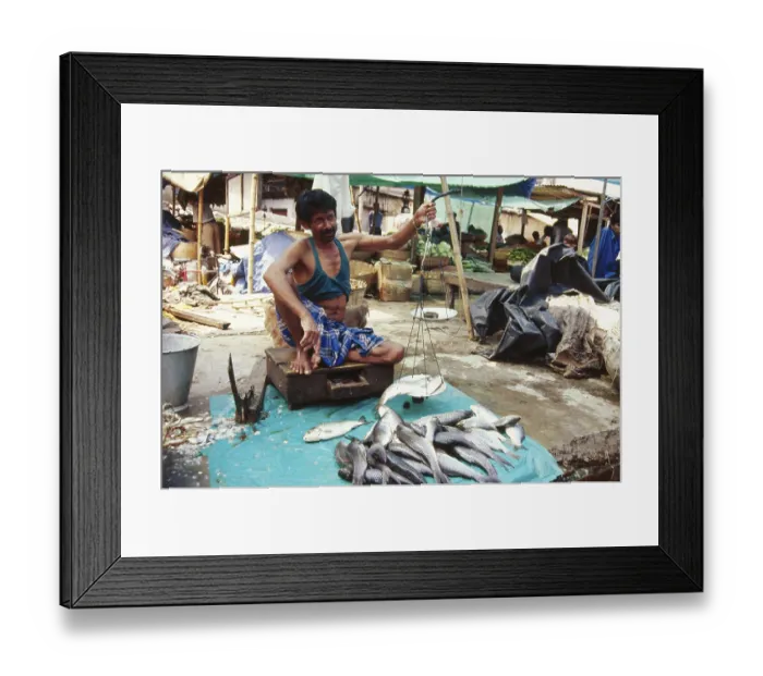 Framed Print : Man selling fish holding Weight scale in market Framed Print : Man selling fish holding Weight scale in market