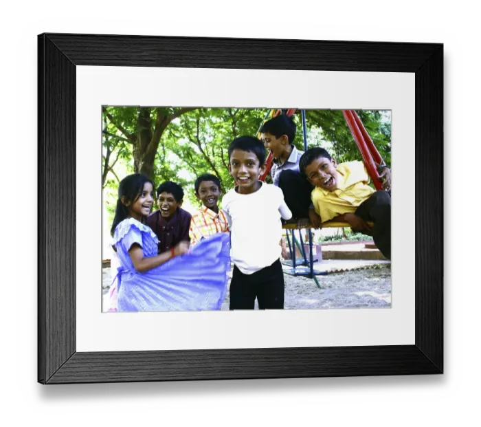 Framed Print : Children playing on swing in a park