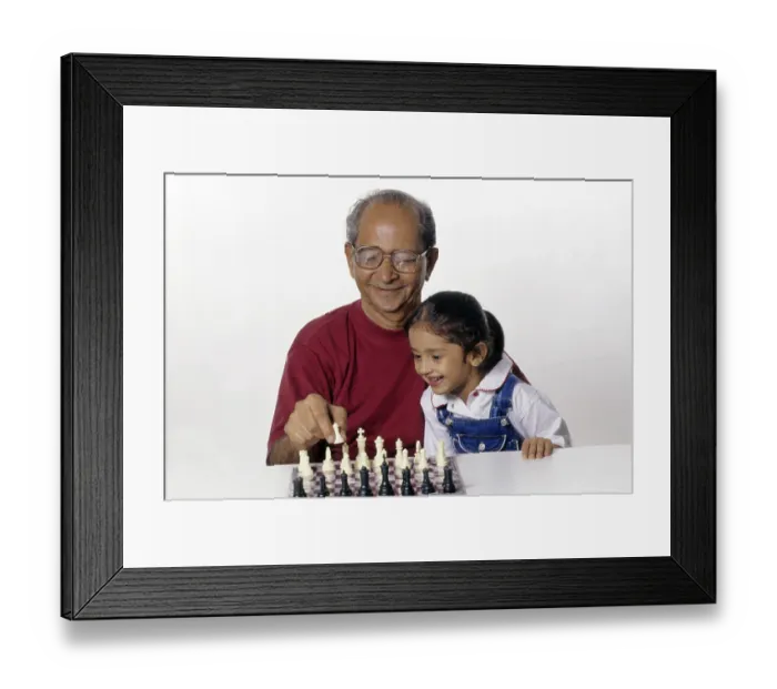 Framed Print : Grandfather and Granddaughter playing chess