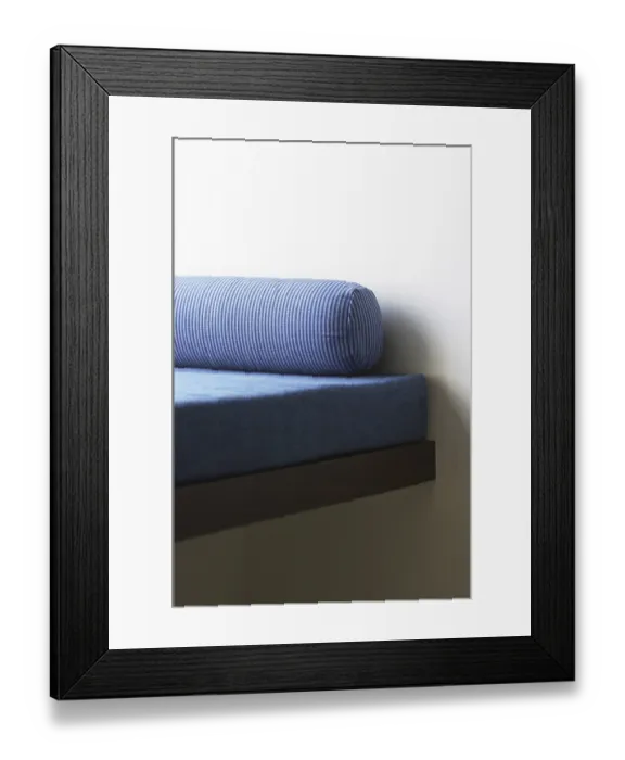 Framed Print : Sofa cum bed with long blue color round cushion