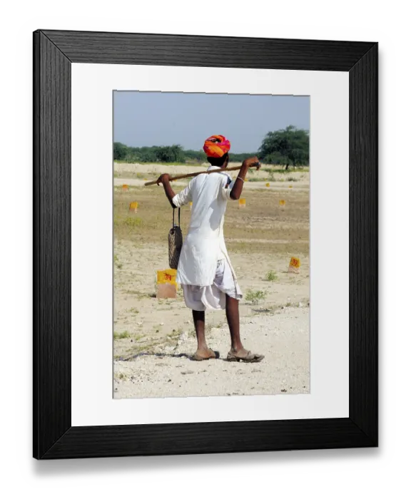 Framed Print : Shepherd standing in field at pushkar