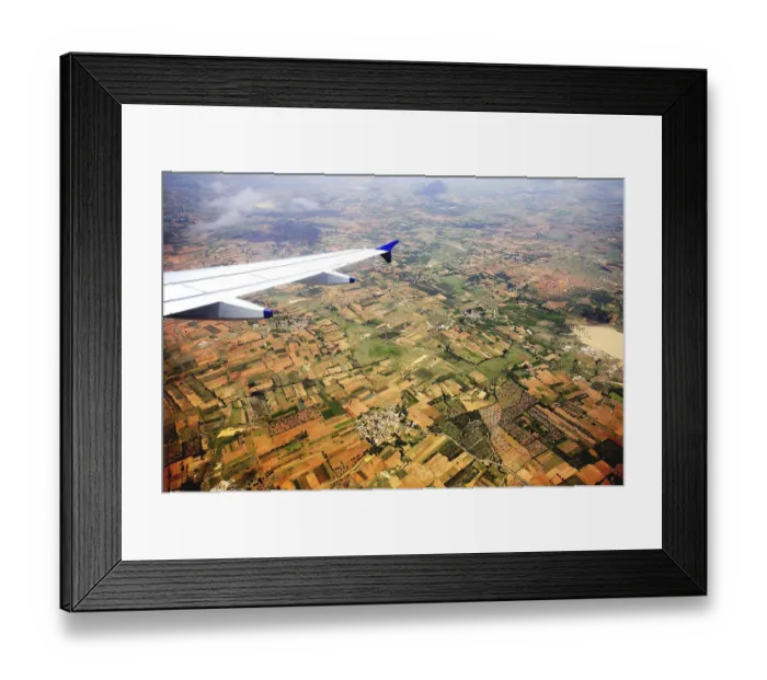 Framed Print : Aerial view of field and aircraft wing