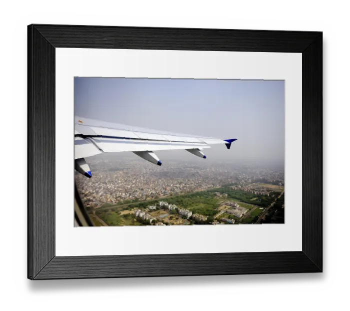 Framed Print : Aerial view of city and aircraft wing