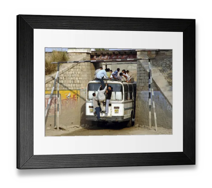 Framed Print : A crowded bus is passing through a narrow bridge