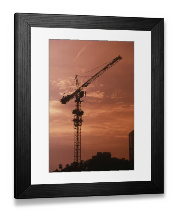 Framed Print : Sunset at background of construction crane